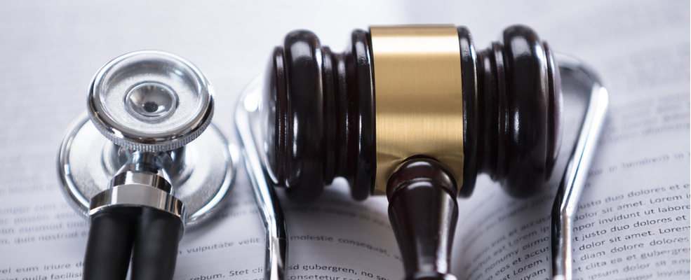 a gavel an stethoscope depicting law and medicine