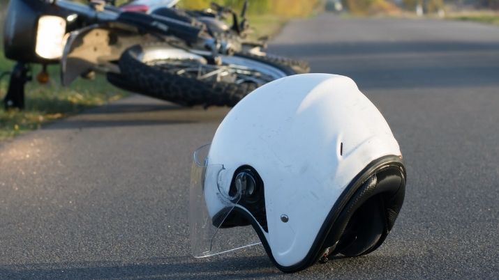 a motorcycle accident with the helmet on the road