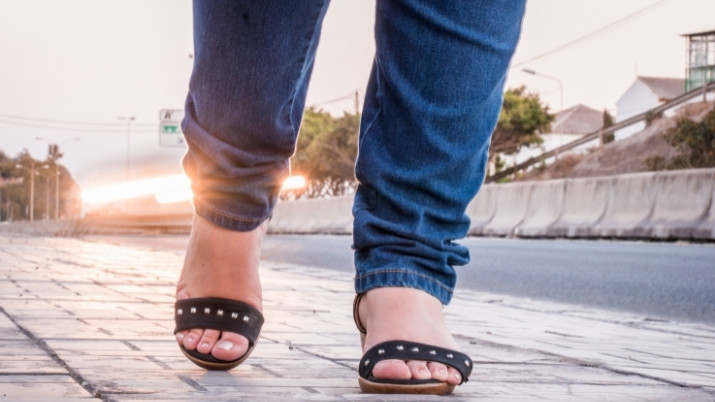 womans feet on a highway depicting pedestrian on highways