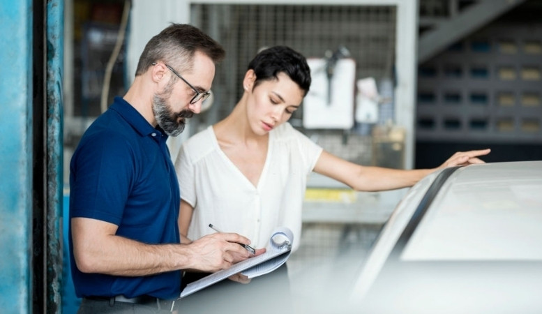 a car owner discussing with an insurance agent