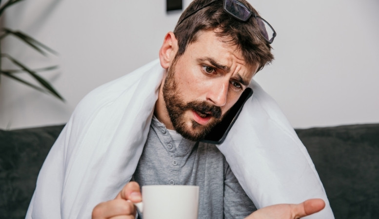 man calling a doctor about his back injury