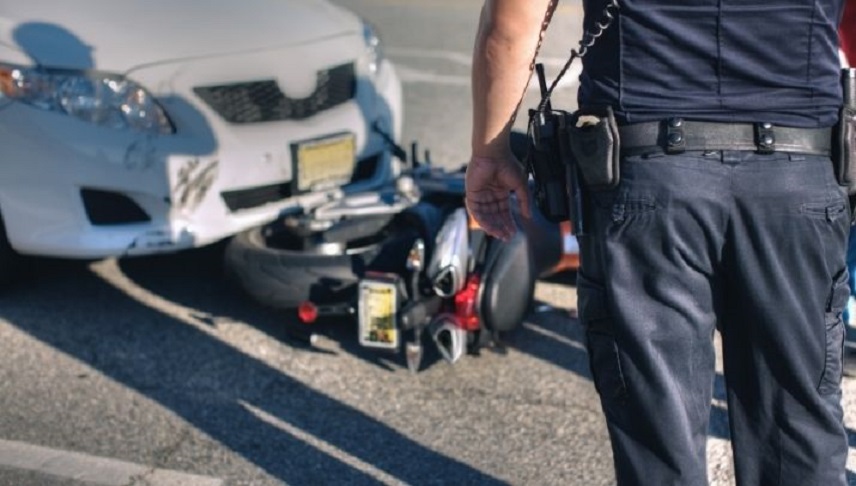 police assesing the situation about a car and motorycle accident