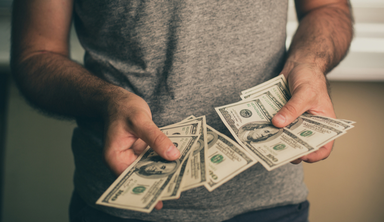 man computing cash received from injury settlement