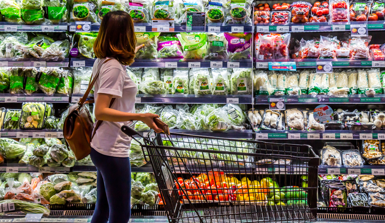 woman picking vegetables in a market