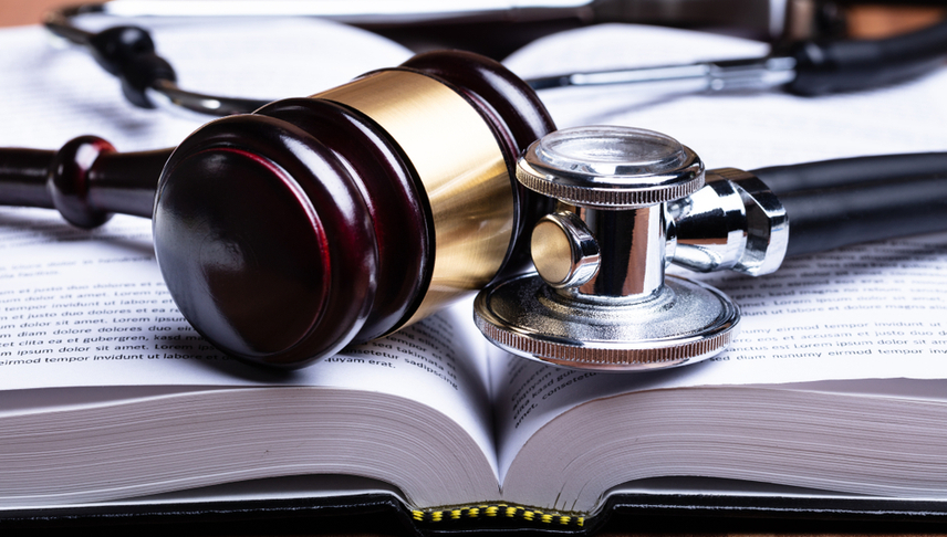 a book with stetoscope and judge gavel