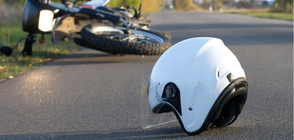 a helmet with a crashed motorcycle