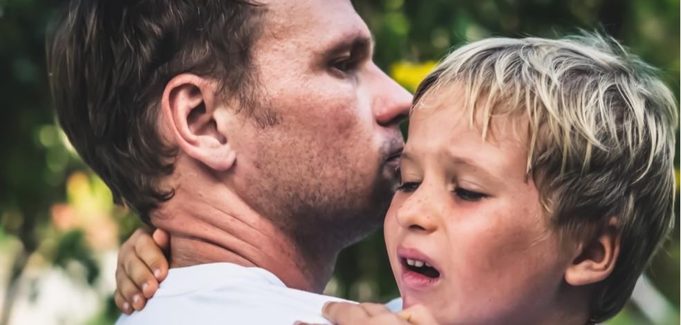 father consoling his child after a car accident