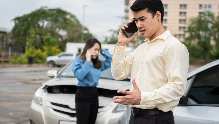 man and woman calling their attorneys after a car accident
