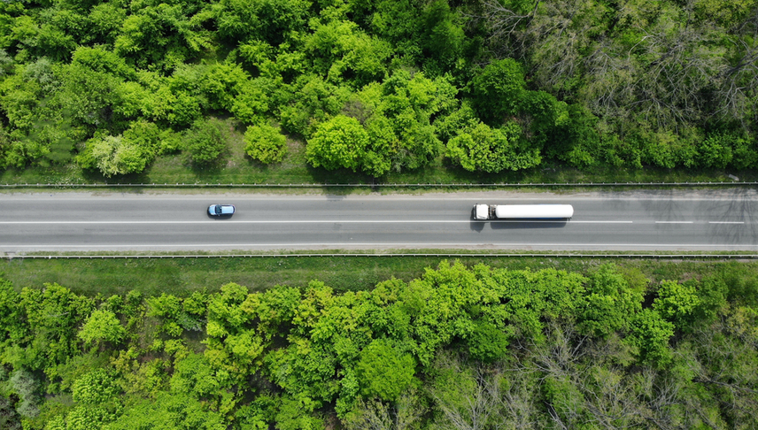 a car and a truck driving in a highway