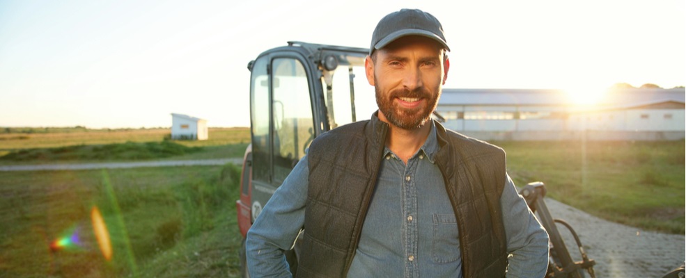 a farmer smiling in the field