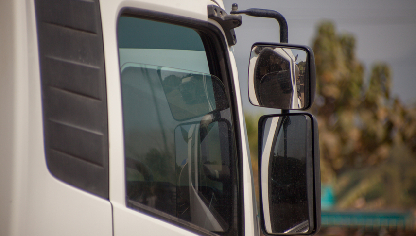 a side mirror of a white truck