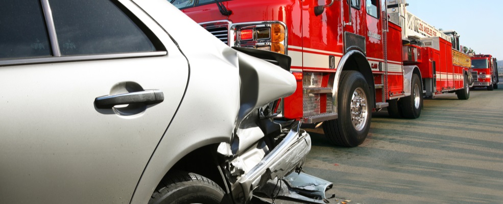 a wreck car hit by a fire truck