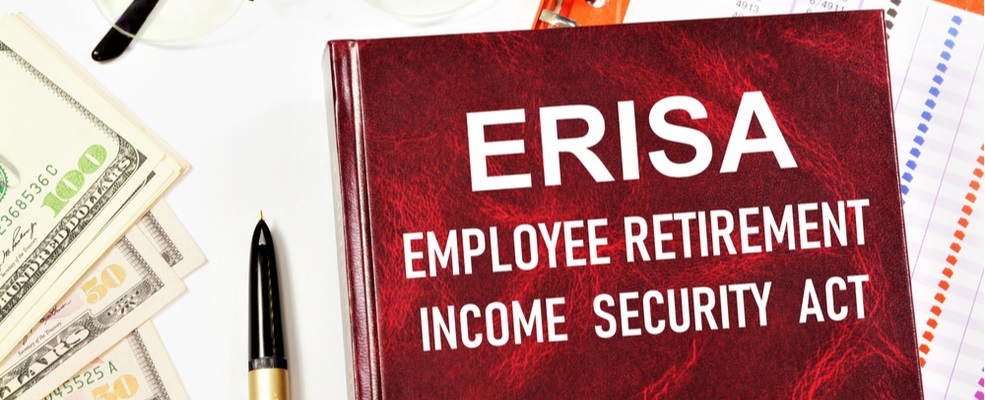 erisa book with a pen and dollar bills on the side