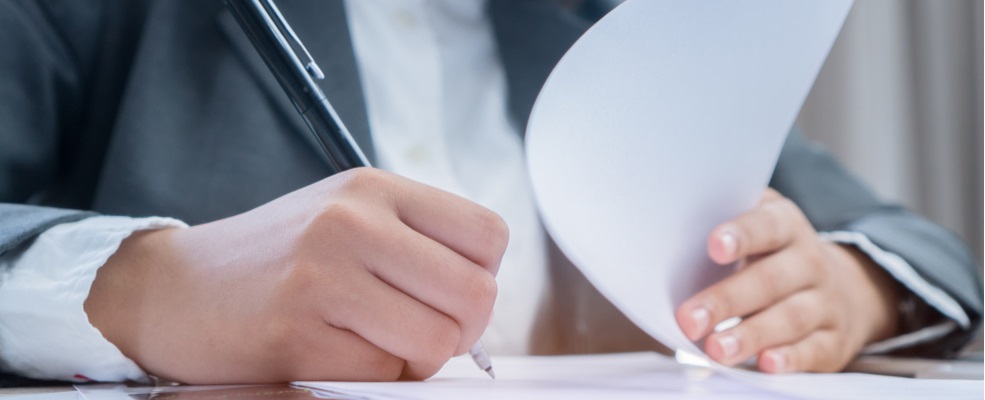 hand writing a document for toxic exposure claim