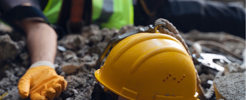 helmet at the side of a unconcious construction worker