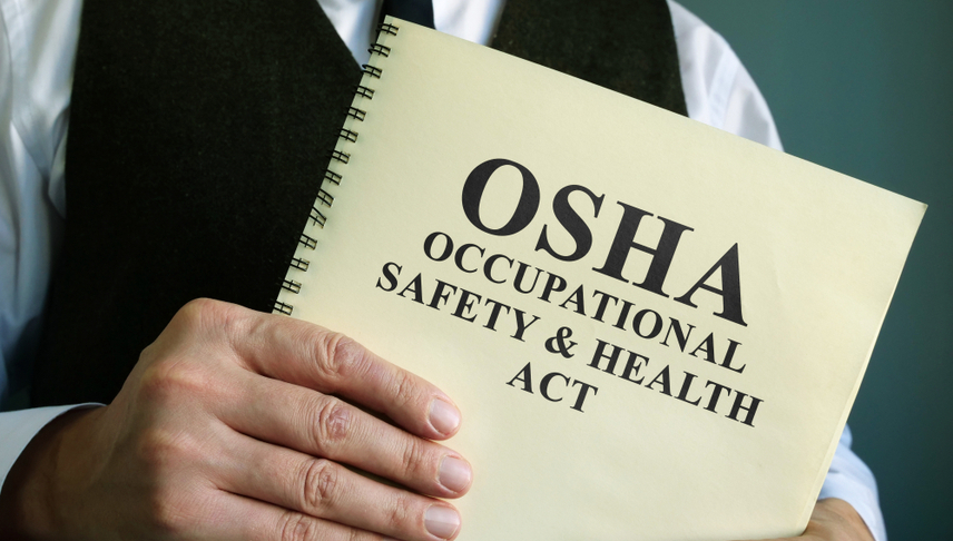 man holding osha manual