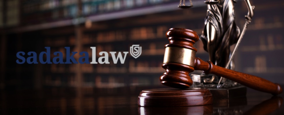 sadaka law logo with a gavel on the side