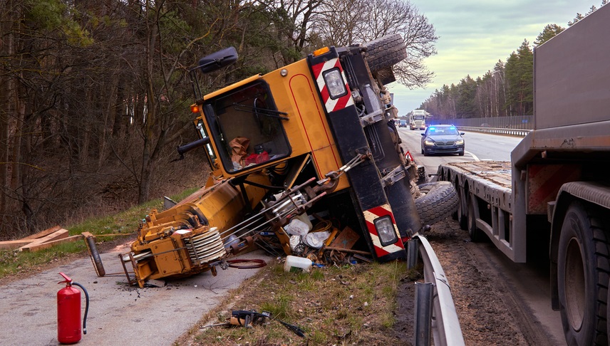 a mobile crane falling from a trailer