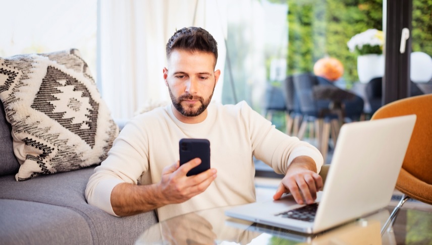 man calling his attorney and checking articles on his laptop about premises liability insurance