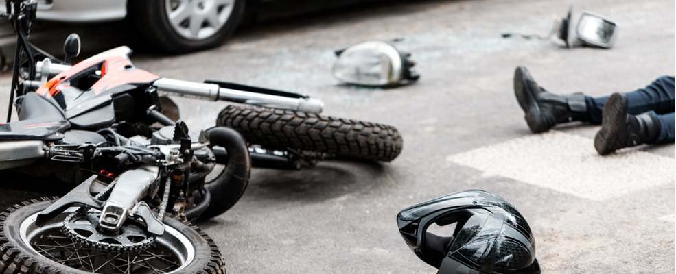 legs of a biker on the road after a motorcycle accident