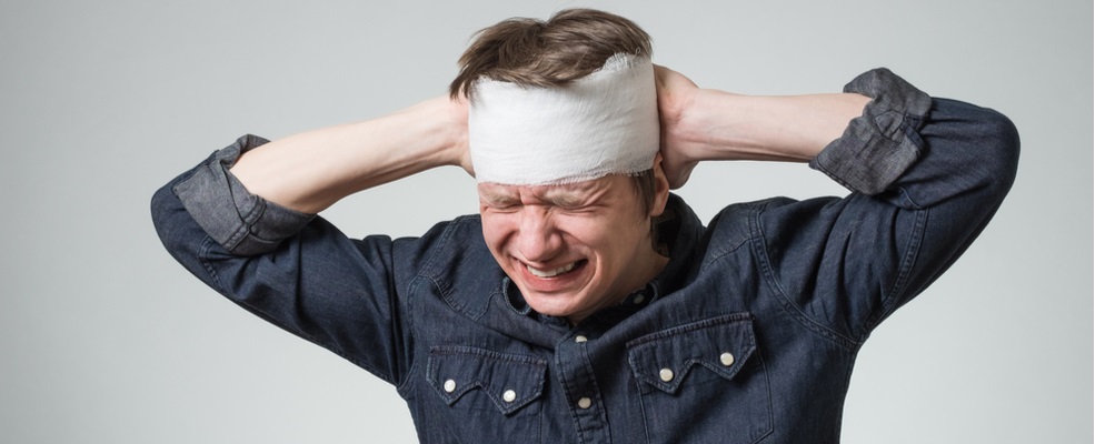 man having pain on his head after a motorcycle accident