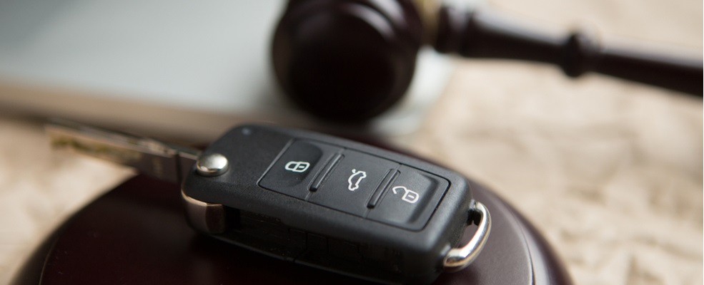 gavel and car key in a table