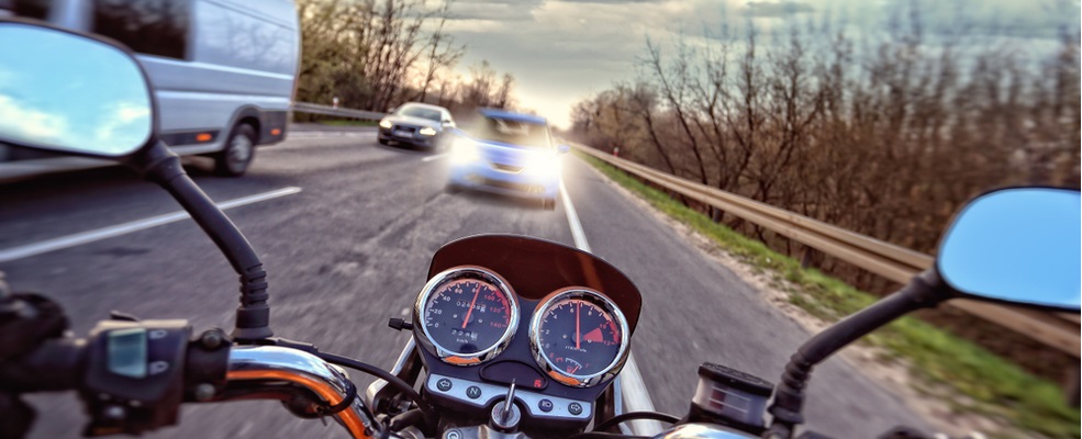 motorcycle near to collide with a car in front