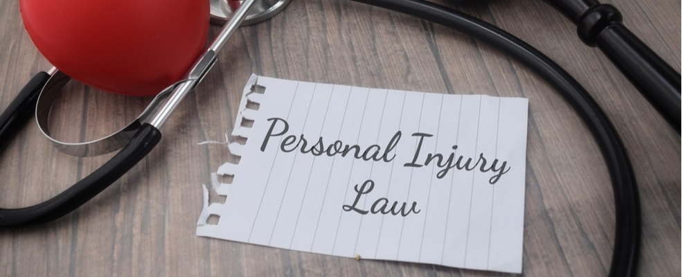 personal injury law written in a note book with stethoscope around