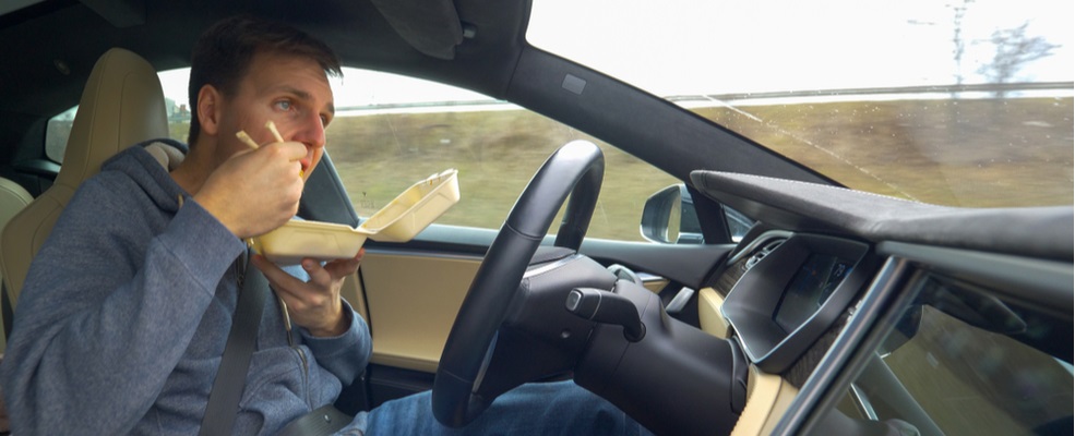 reckless man eating while driving