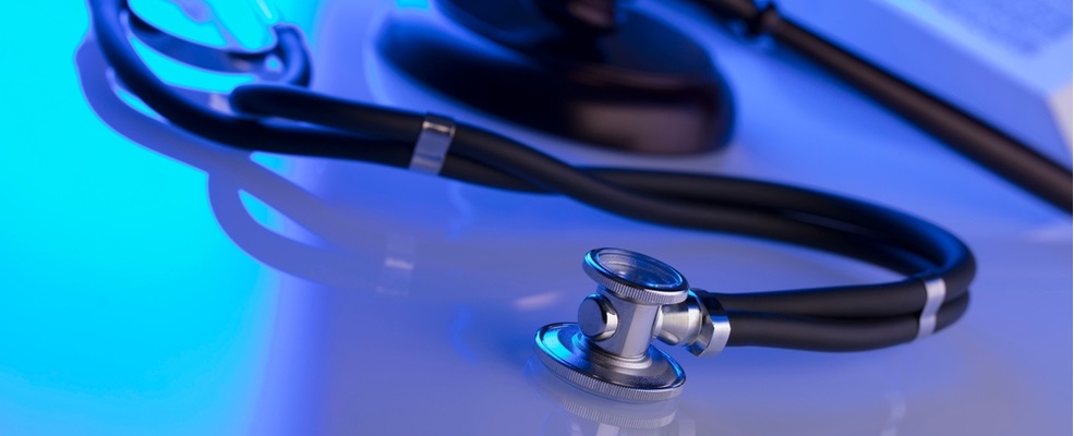 stethoscope and gavel in a clear table with blue light