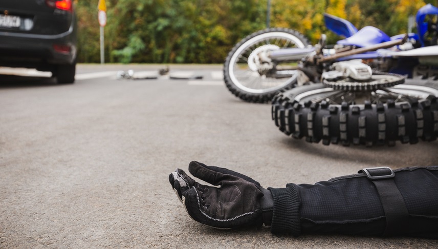 man lying down in the street after he got into a motorcycle accident