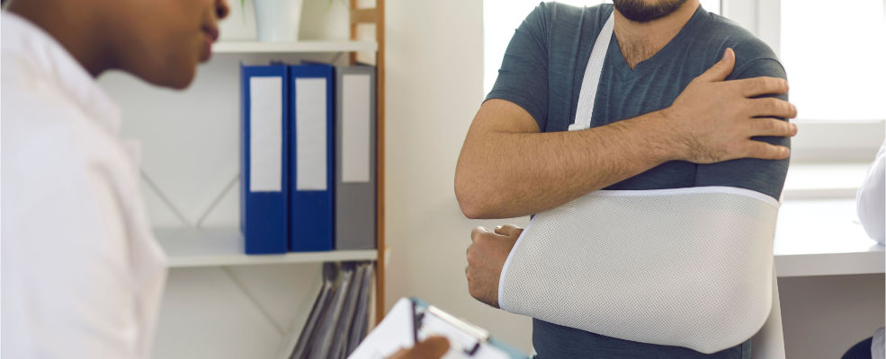 following a car accident patient wearing injury support consults with a doctor