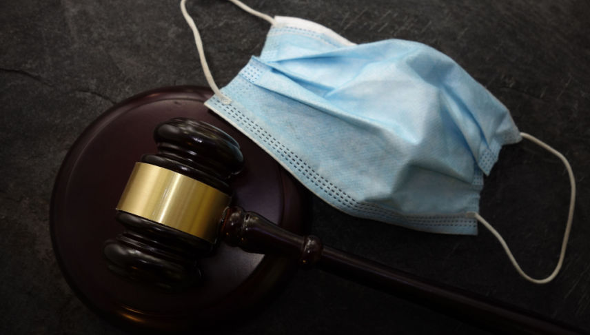 gavel and facemask on black background
