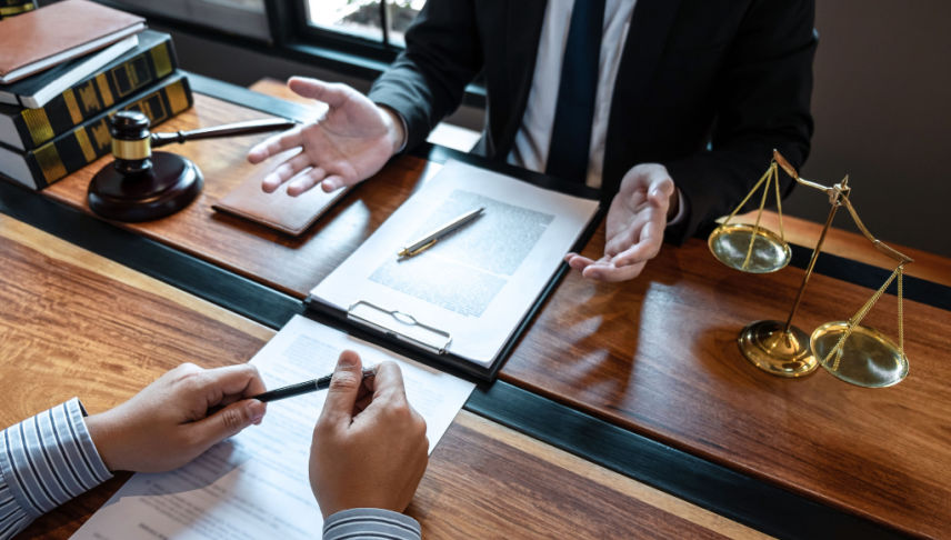 male lawyer discussing class action case to his client