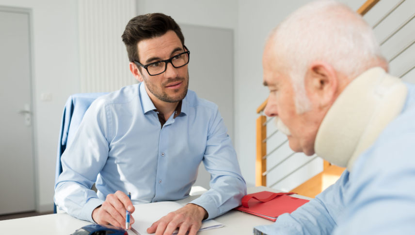 personal injury lawyer meeting with client wearing neck brace