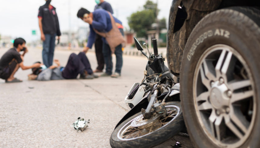 man calling ambulance after accident cause by motorcycle lane splitting