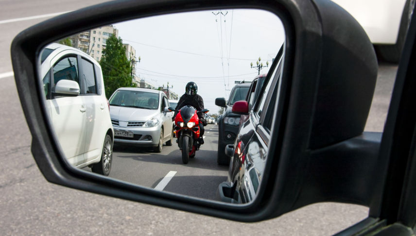 red motorcycle moves between the lane