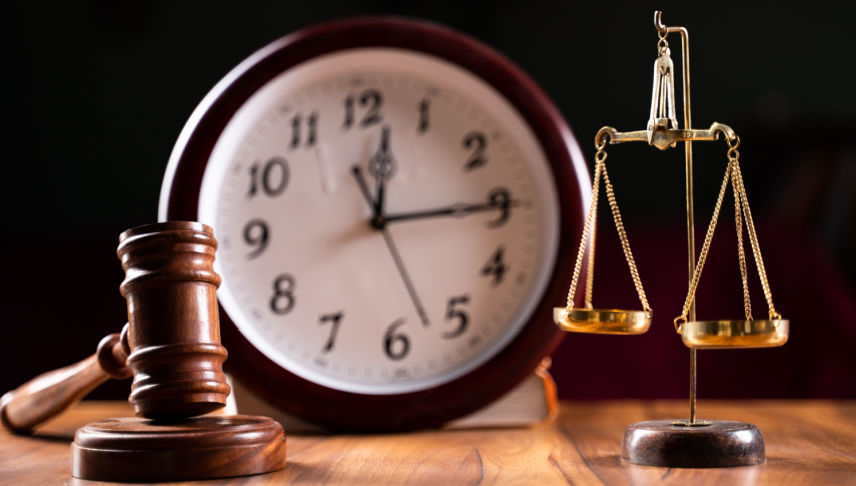 judge gavel balance scale with the clock on background