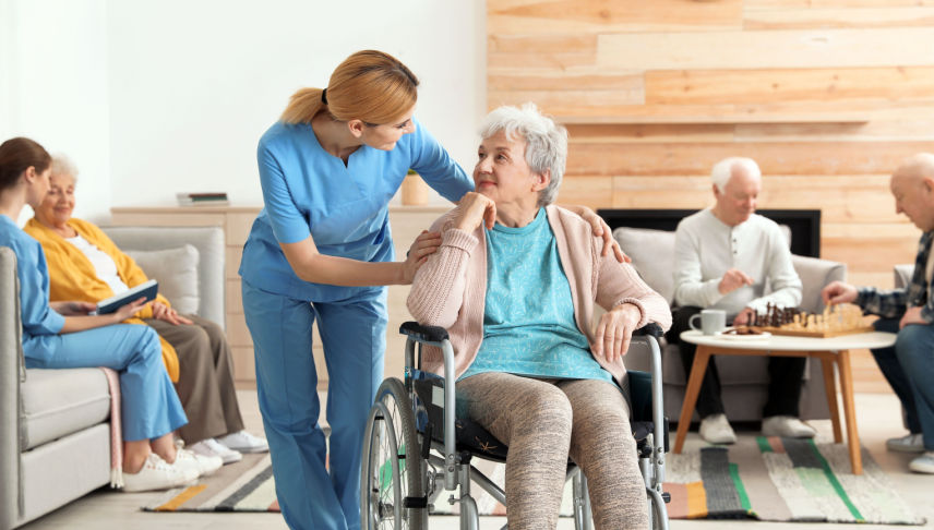 nurse assisting elderly people at nursing home