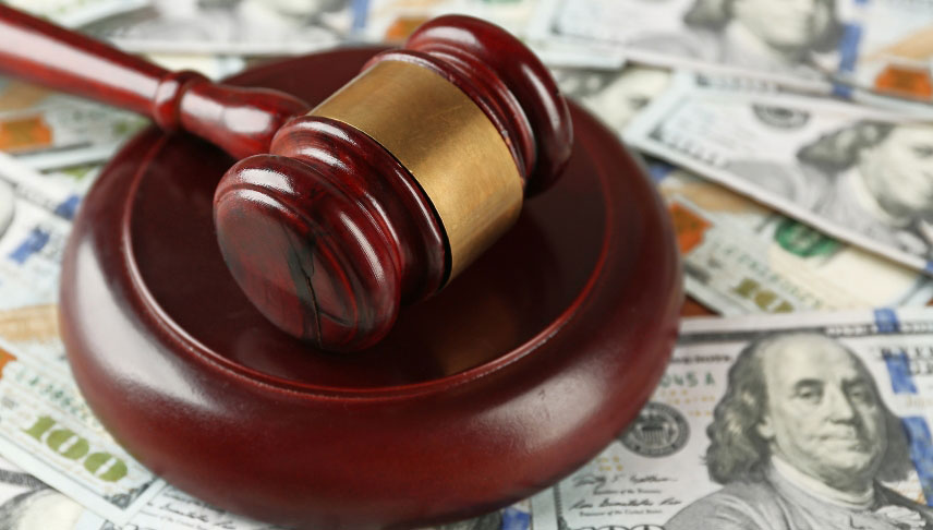 judge gavel with dollar banknotes on background