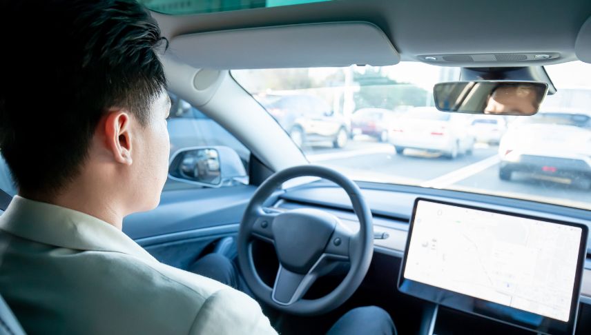 man driving using a self driving car