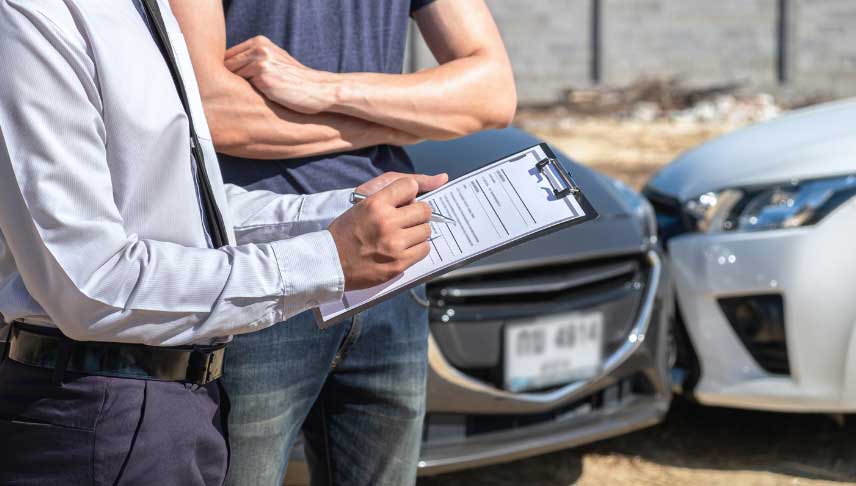 insurance agent examining car accident