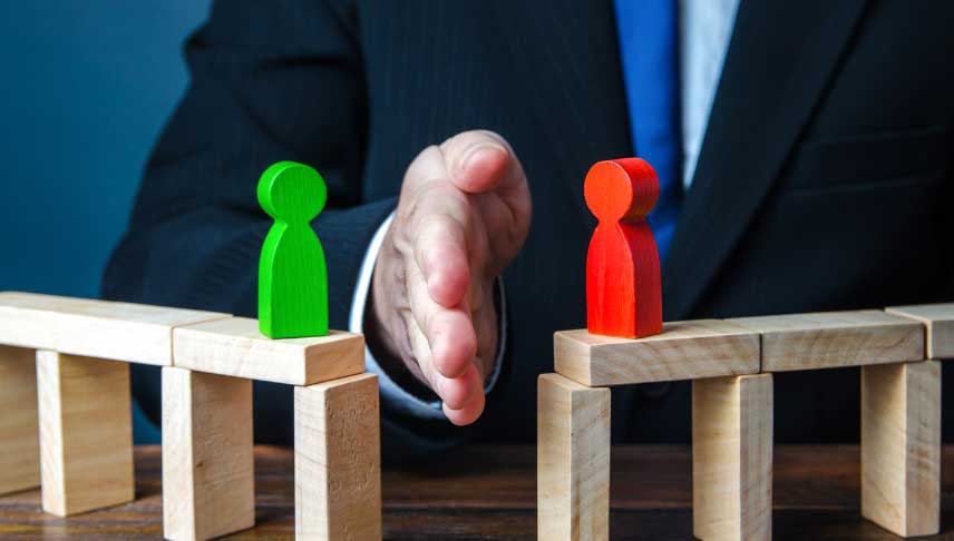 lawyer hands between two wooden human green and red block