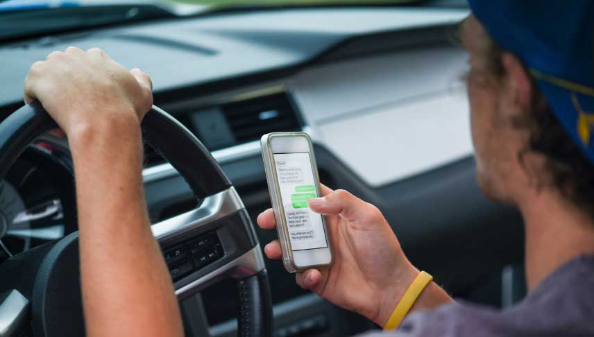 man using cellphone while driving