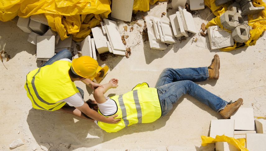 man helping his coworker in construction accident