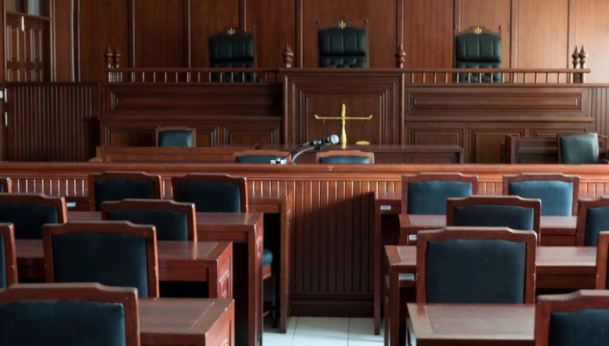 chairs and tables on empty courtroom