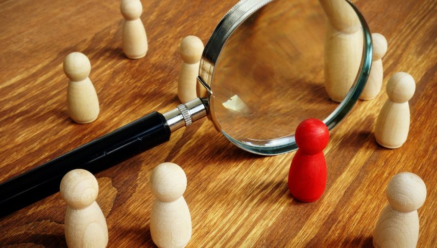 magnifying glass and human wooden blocks in red and brown color