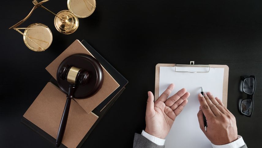 judge gavel scale and documents on a table