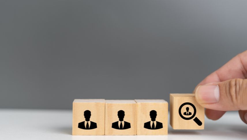 wooden blocks with human icon and magnifying glass