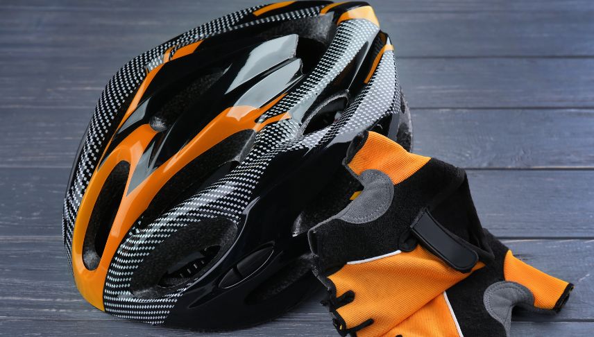 black and orange bicycle helmet and glove
